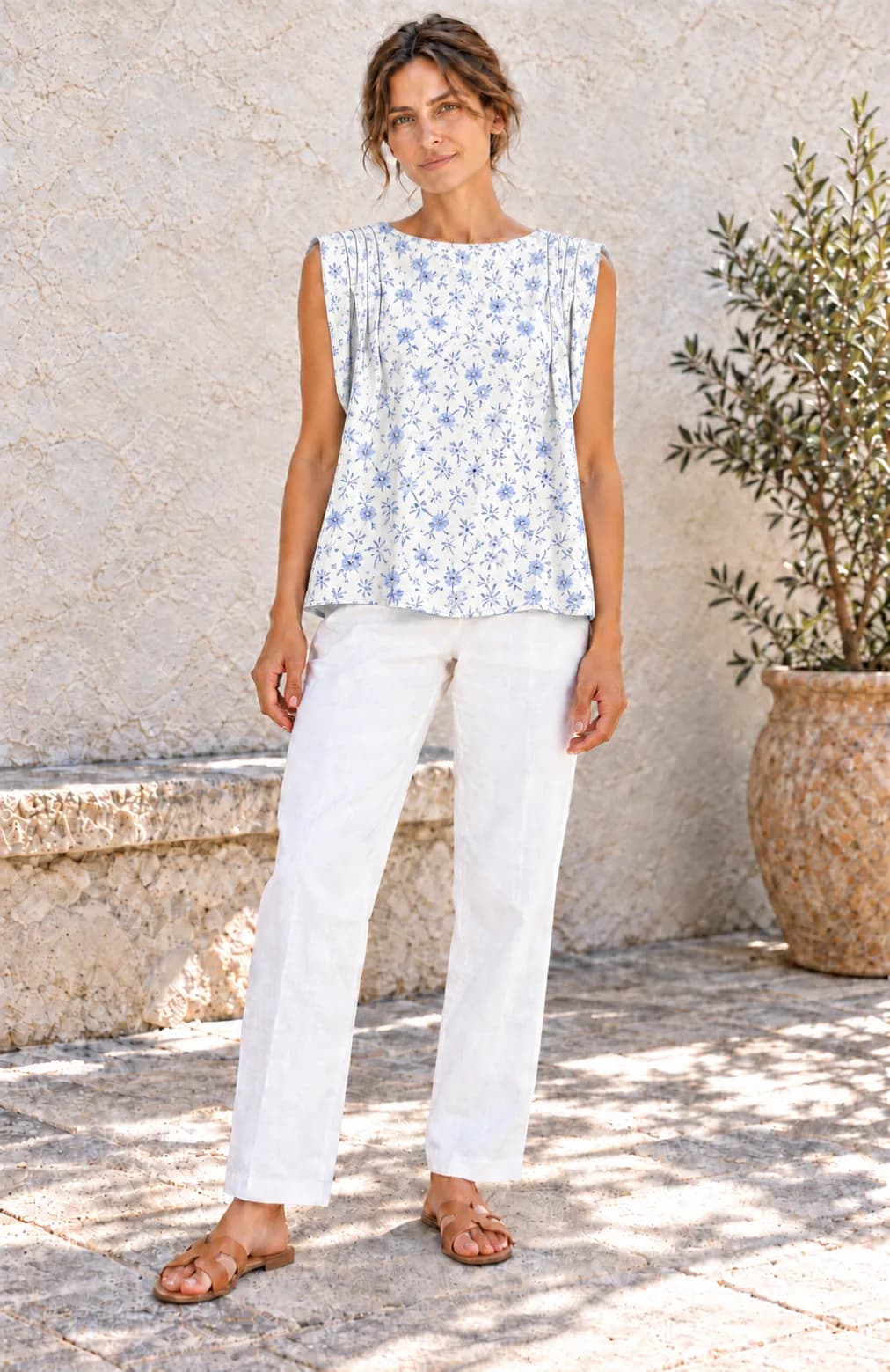 The same woman in the dp’s top “le 5005” with blue flowers and white trousers